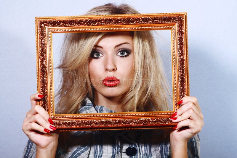 Young beautiful woman in a frame stock photos
