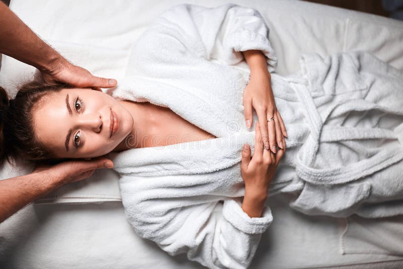 Beautiful Young Woman Receiving Massage On Head And Shoulders Zone In Spa Centre Stock Image