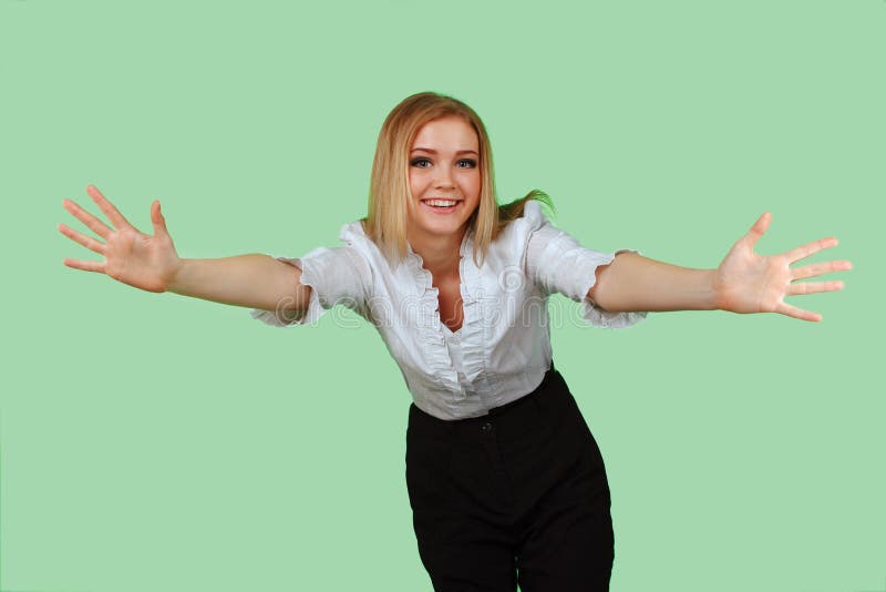 Young beautiful woman with her hands wide apart on the green screen