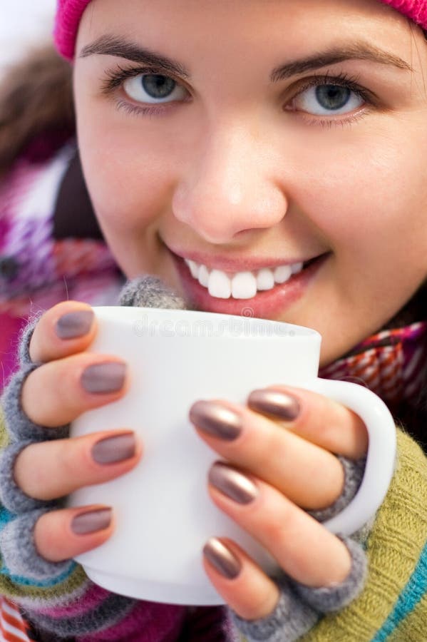 Young beautiful woman holding a cup of coffee