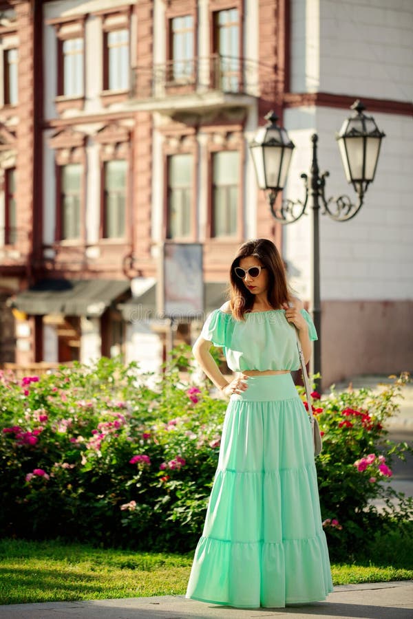 Young Beautiful Woman in a Light Green Pastel Long Dress is Walk Stock ...