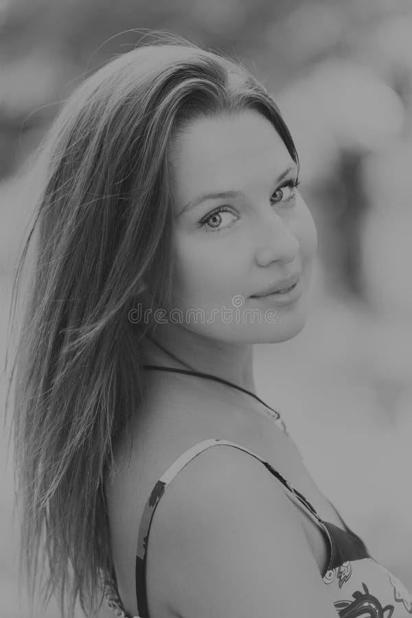 A Beautiful Woman In A Stylish Dress On A Dark Background Stock Image