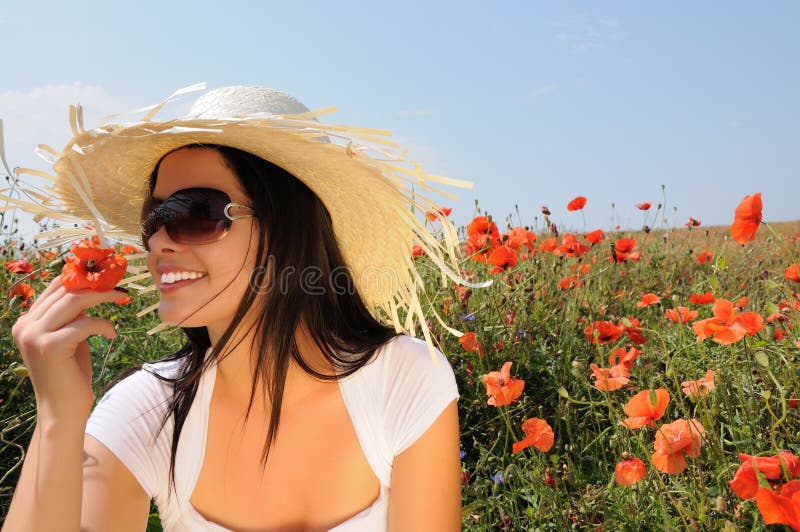 Young beautiful woman in poppy flowers