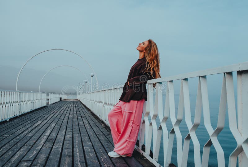 Young beautiful woman posing on pier royalty free stock images