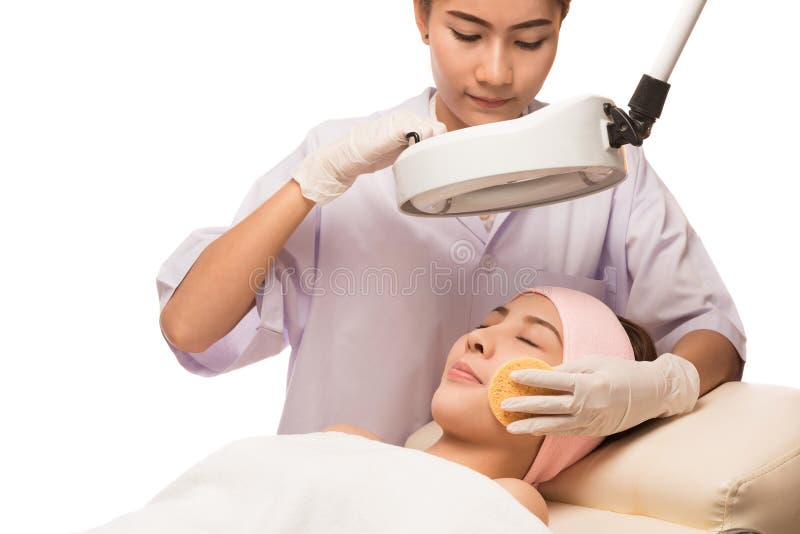 Young beautiful woman receiving cosmetic facial mask in spa stock image Young beautiful woman receiving cosmetic facial mask in spa stock image