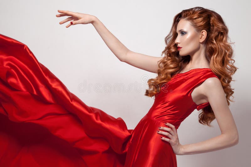 Young beautiful woman in red dress.