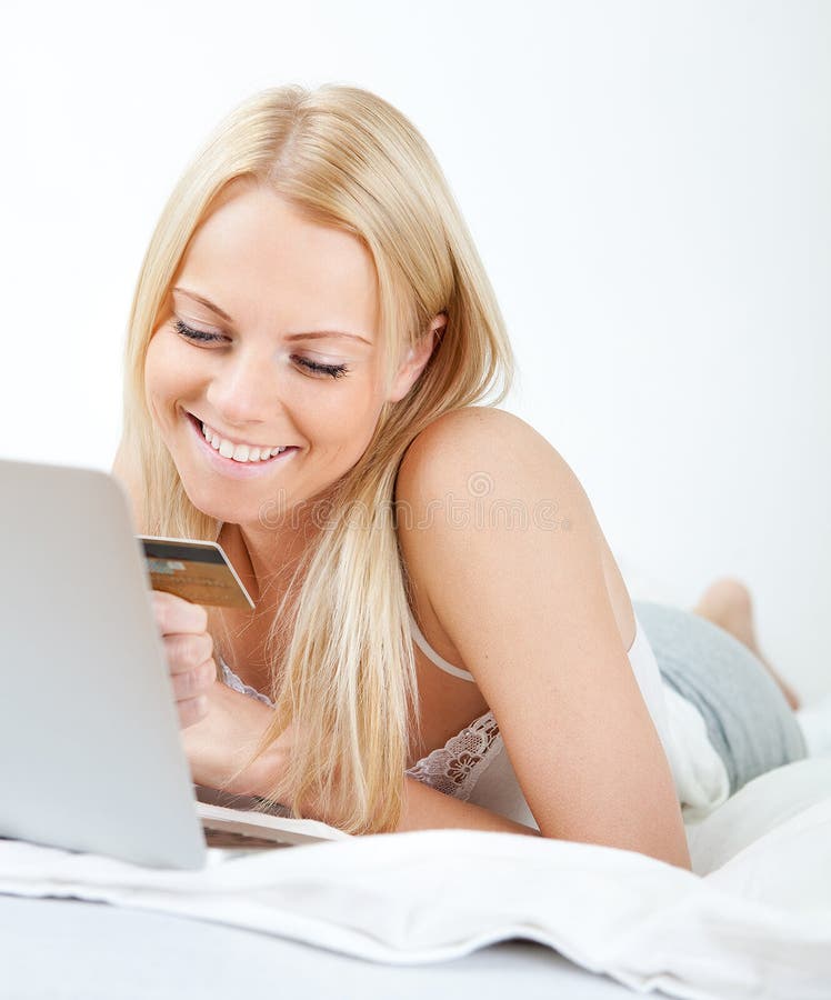 Young beautiful woman shopping using laptop