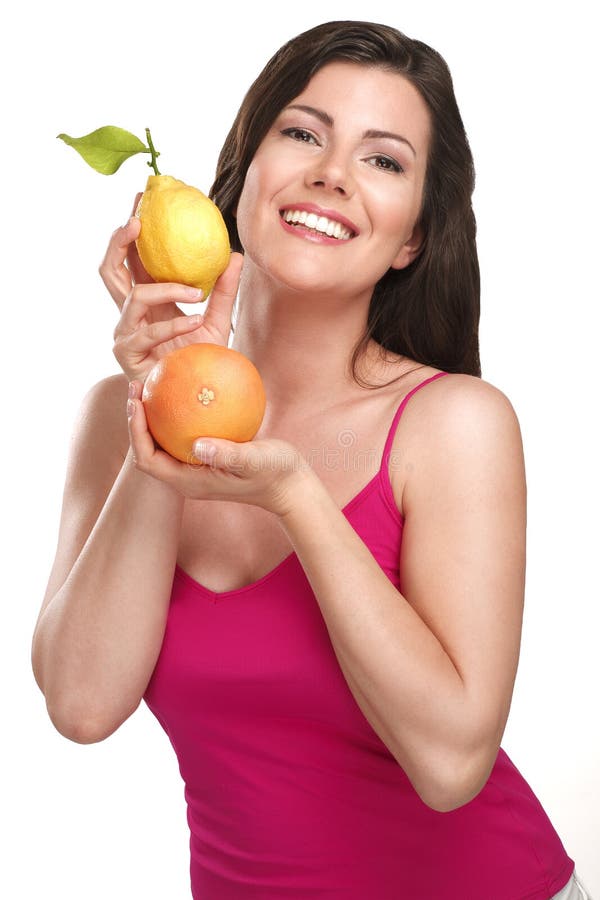 Young beautiful woman showing fresh fruits of season