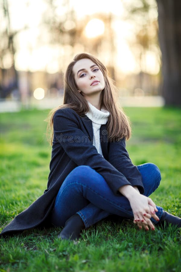 Young beautiful woman sitting on a grass in sun light on sunset royalty free stock images Young beautiful woman sitting on a grass in sun light on sunset royalty free stock images