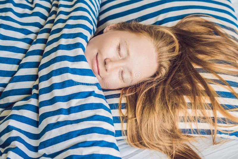 Young beautiful woman sleeping in her bed and relaxing in the mo royalty free stock image Young beautiful woman sleeping in her bed and relaxing in the mo royalty free stock image