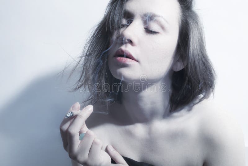 Young beautiful woman smoking cigarette stock photography Young beautiful woman smoking cigarette stock photography