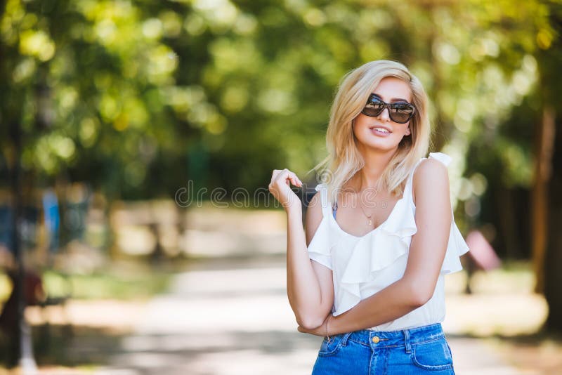 Young Beautiful Woman in Sunglasses at Sunny Day in Park Stock Photo ...