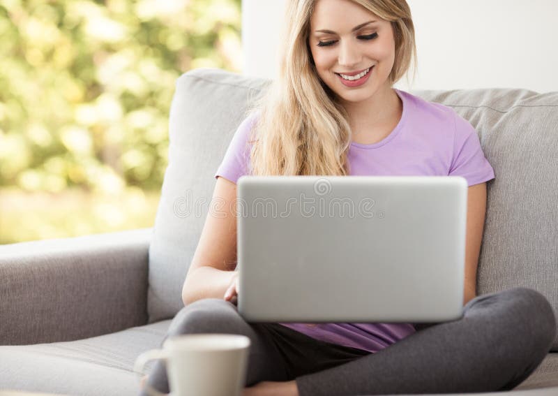 Young beautiful woman using a laptop at home