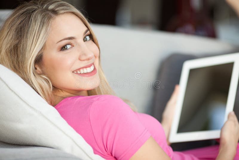 Young beautiful woman using tablet at home