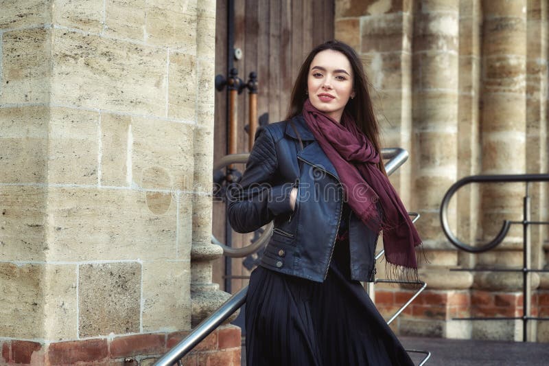 Young beautiful woman on a walk around the city . The girl wears a black jacket and skirt . royalty free stock images Young beautiful woman on a walk around the city . The girl wears a black jacket and skirt . royalty free stock images