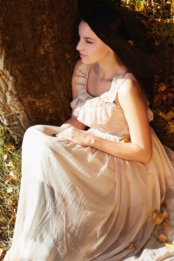 Young beautiful woman walking in autumn forest