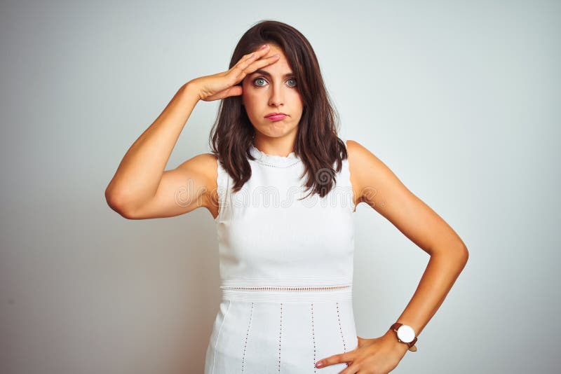 Young beautiful woman wearing dress standing over white isolated background worried and stressed about a problem with hand on