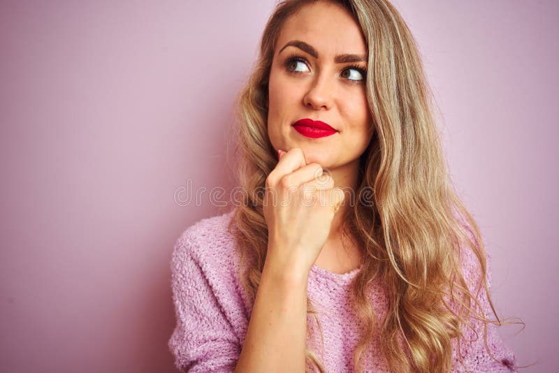 Young beautiful woman wearing sweater standing over pink  background serious face thinking about question, very confused