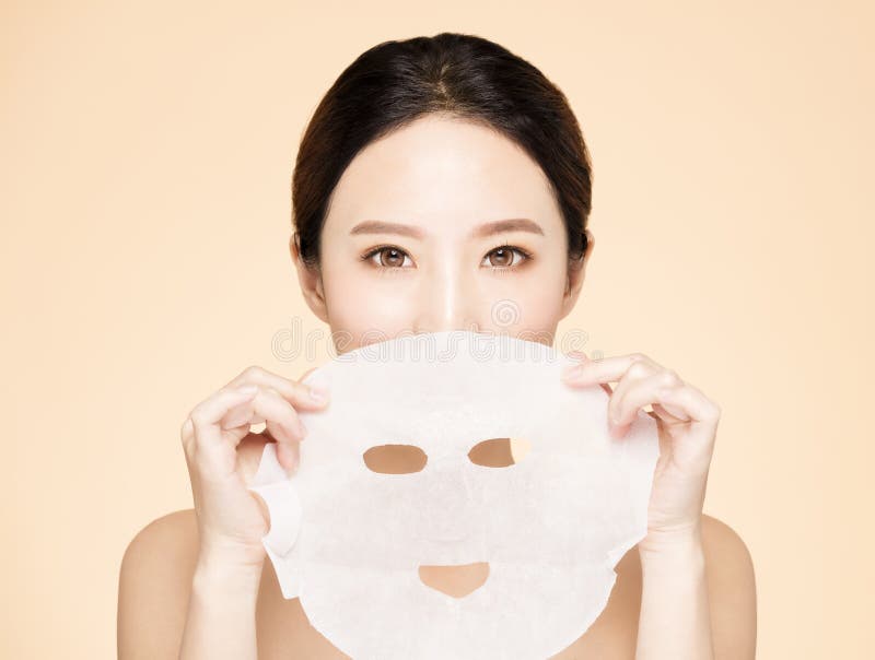 Young beauty face and facial mask stock image Young beauty face and facial mask stock image