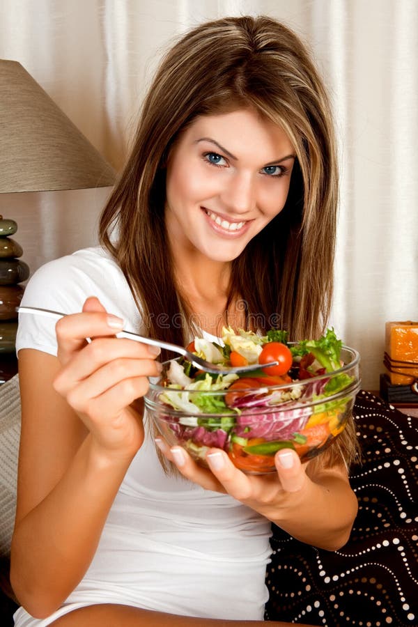 Young beauty woman eating salad