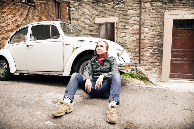 Young Beauty Woman Sitting On The Road Against ret