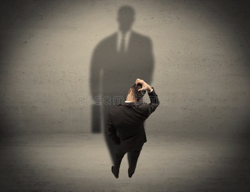 Businessman looking at big shadow concept