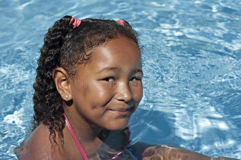 Young black baby girl in swimming pool on vacation. Young black baby girl in swimming pool on vacation