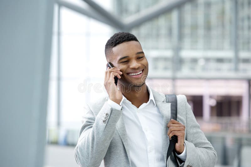 Young black man smiling with cellphone