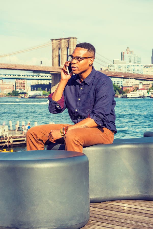 Young Black Man Talking on Cell Phone Outdoors in New York City Stock ...