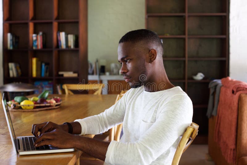 Young black man using laptop computer