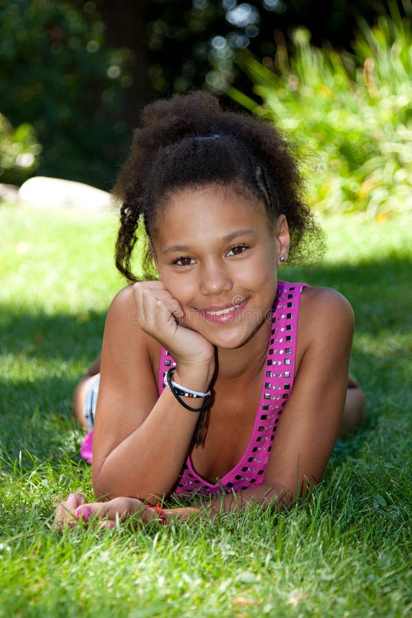 Young Black Teenage Girl Lying On The Grass Royalt