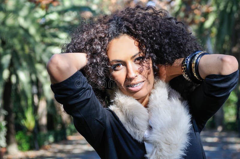 Young black woman, afro hairstyle, in urban background royalty free stock photo Young black woman, afro hairstyle, in urban background royalty free stock photo