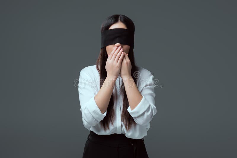 Young Woman Wearing Black Blindfold Isolated On Grey Stock Photo