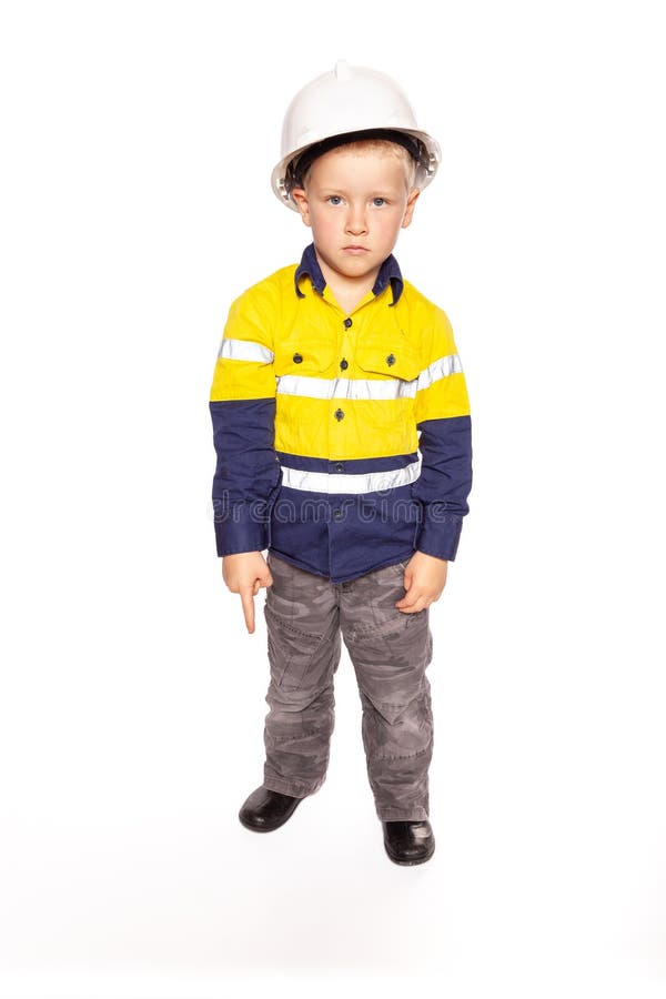 Young blond caucasian boy pointing down with a fierce look role playing as a construction worker supervisor stock image Young blond caucasian boy pointing down with a fierce look role playing as a construction worker supervisor stock image