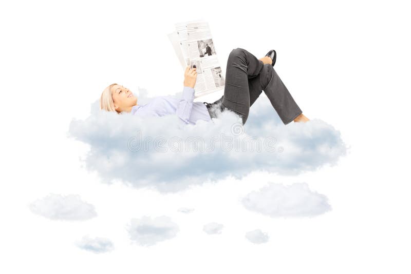 Young blond female reading a newspaper and lying on clouds