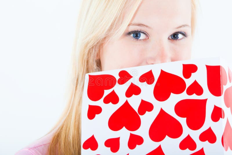 Young blond woman with big valentine post card