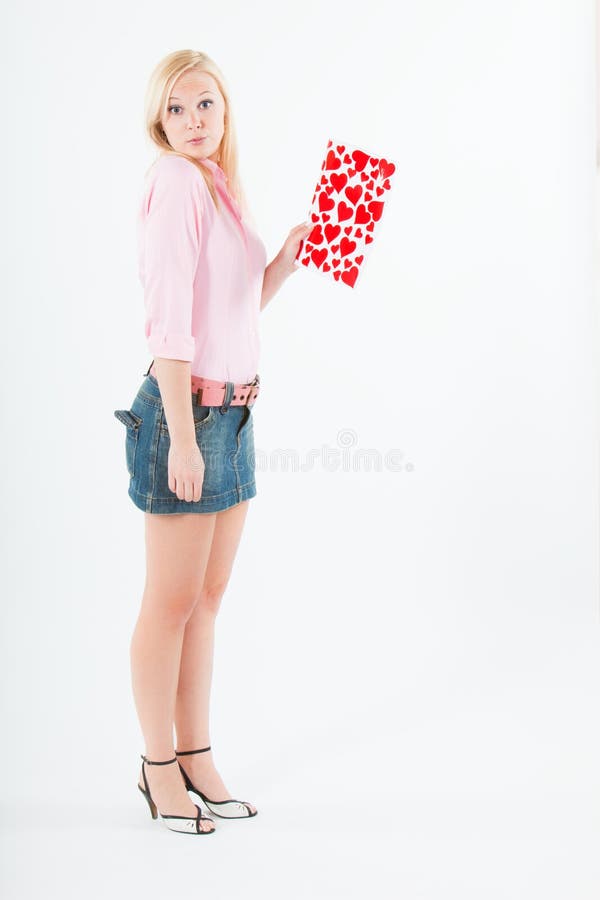 Young blond woman with big valentine post card