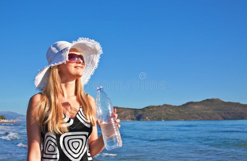 Young blond woman with bottle of water