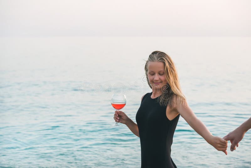 Young Blond Woman Enjoying Glass of Rose Wine and Holding Man S Hand on ...