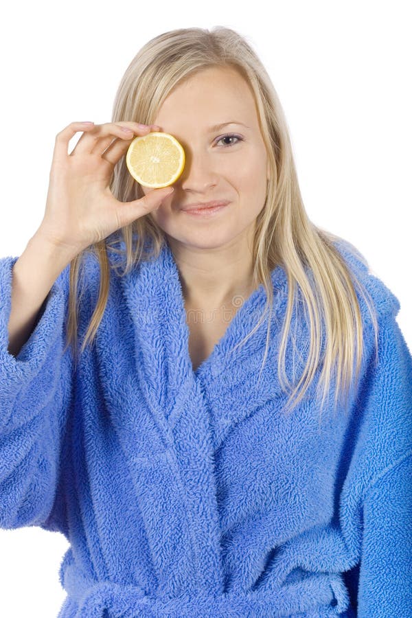 Young blond woman with half of lemon