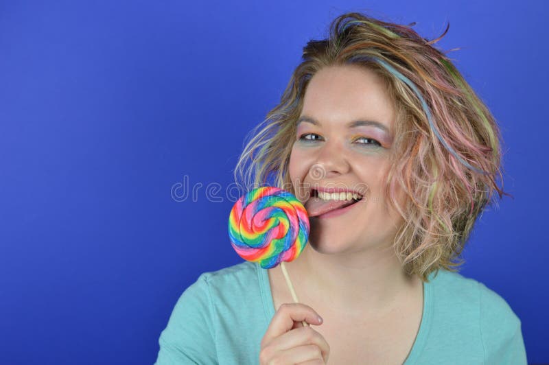 Young blond woman licking at a large lollipop stock photos Young blond woman licking at a large lollipop stock photos