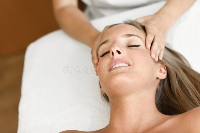 Young Woman Receiving A Head Massage In A Spa Center Stock Image