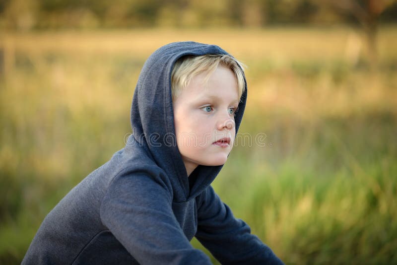 Young Blonde Boy Wearing Hoodie Riding Bike on Dry Country Lane Stock ...