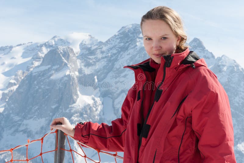 Young blonde Caucasian woman girl posing in Alps mountains with ski equipment