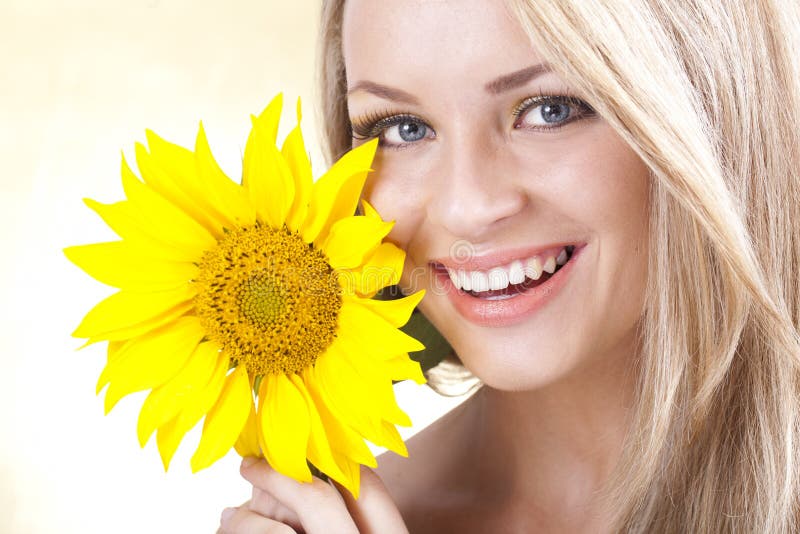 Young blonde girl and sunflower