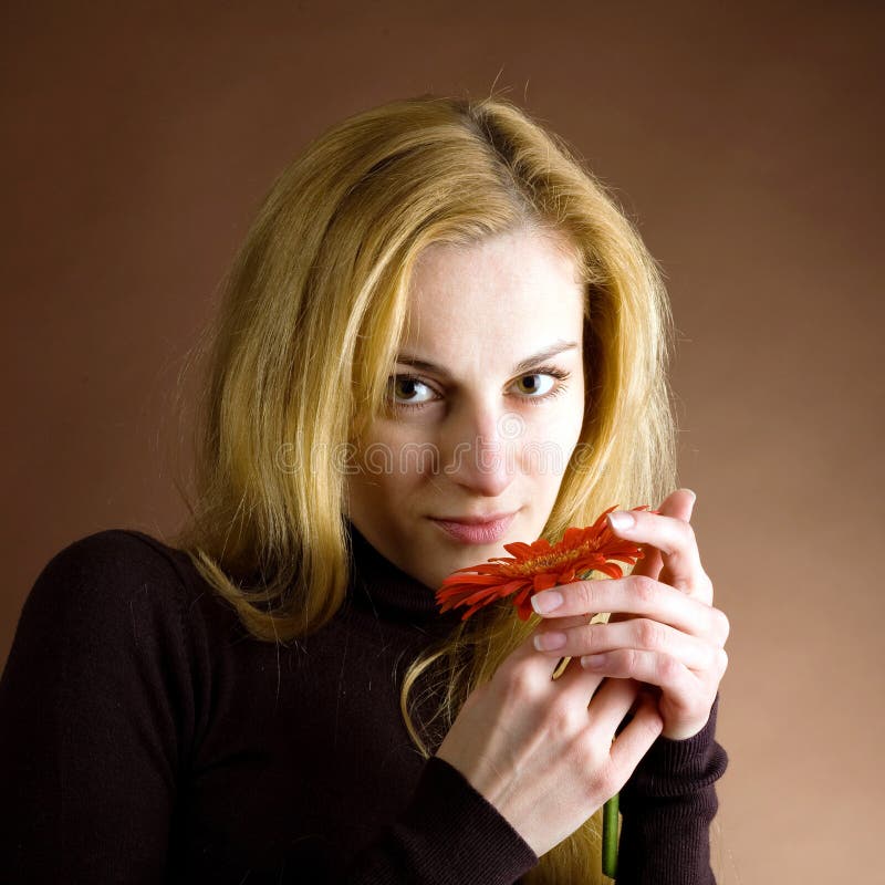 Young blonde with a red flower