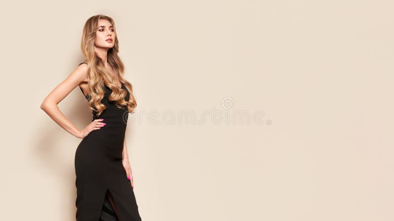 Young blonde woman in black evening dress