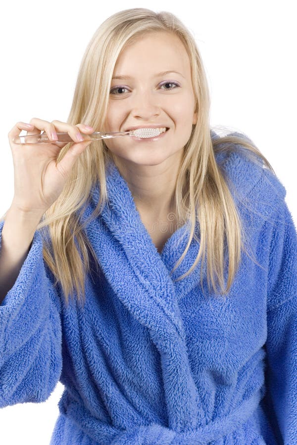 Young blonde woman brushing teeth