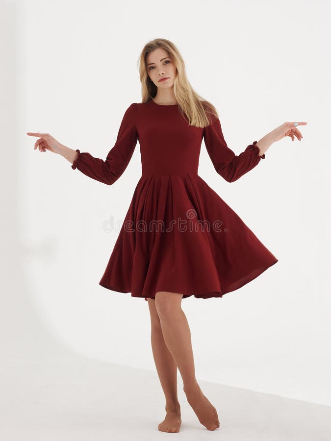 Young blonde woman in cherry red dress