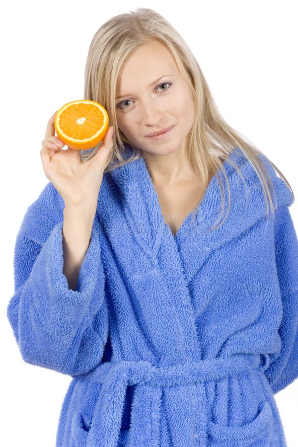 Young blonde woman with half of orange